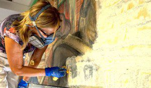 Anna Frassine, Italian Mural Conservator removes the last layer of paint.